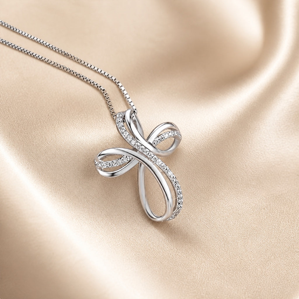 White gold necklace with an intertwined cross pendant